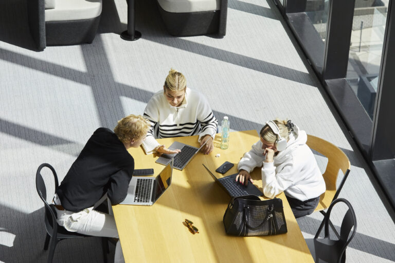 Three students working with their laptops