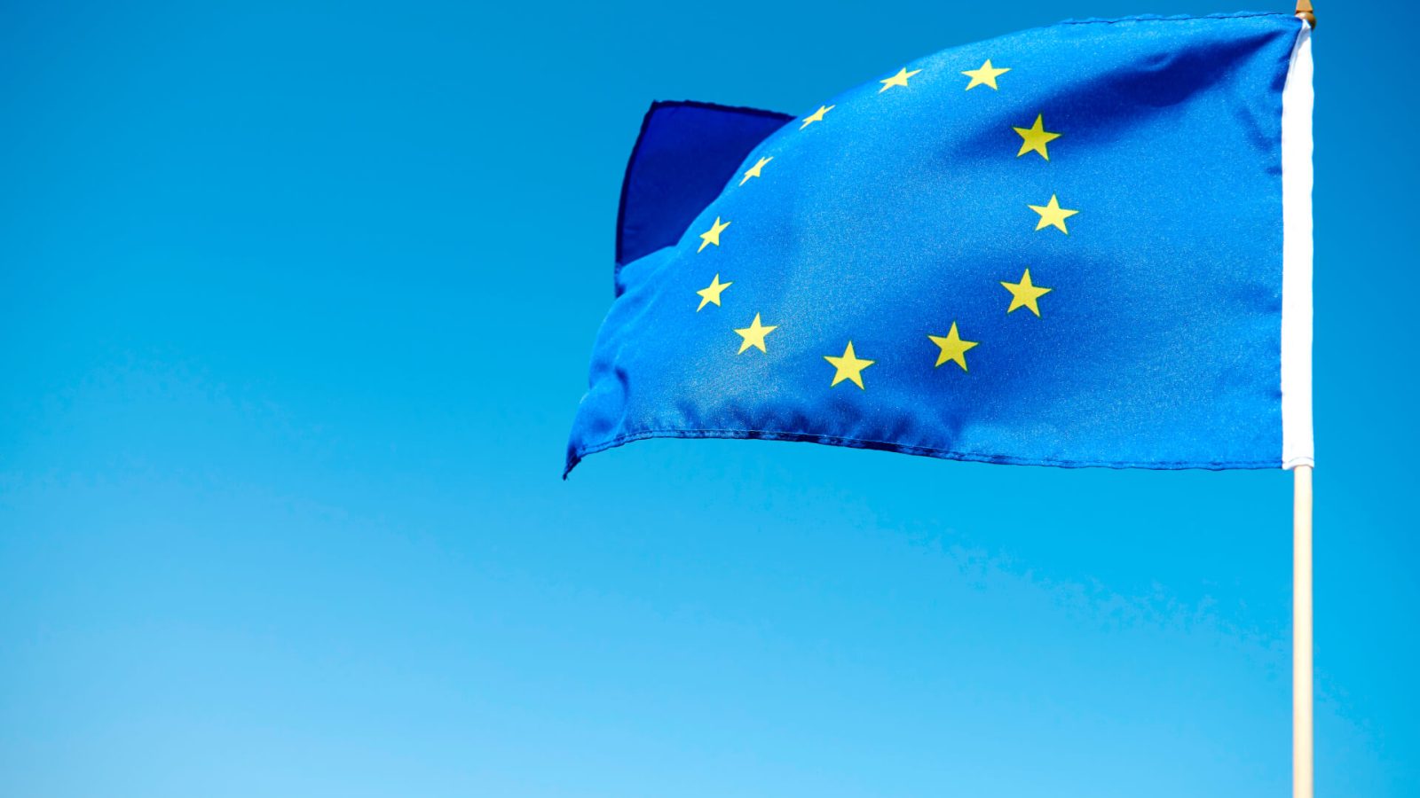 waving-european-union-flag-blue-background
